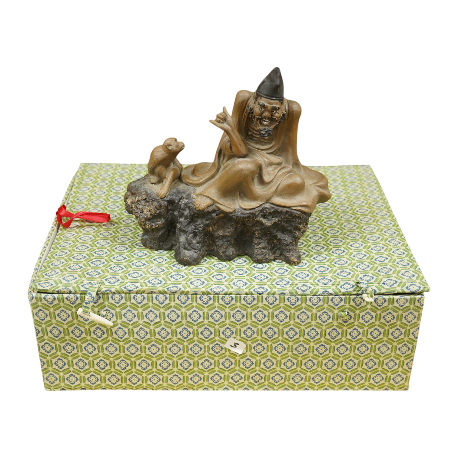 A Chinese Shiwan figure group of a luohan and monkey, housed in a fitted box, 21cm wide. Condition - good